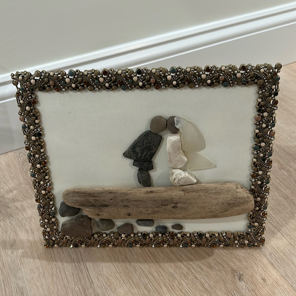 Pebble art frame of wedding engagement couple with rock and driftwood​